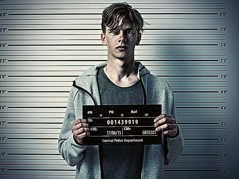 In a Police Station Arrested Drug Addict Teenage Posing for a Front View Mugshot