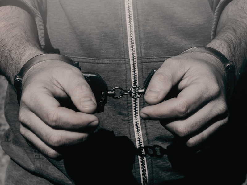 a man with handcuffs on his wrists