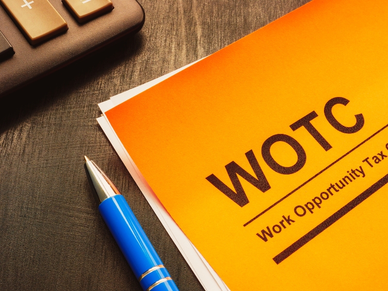 Work opportunity tax credit WOTC application, pen and notepad.
