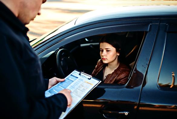 Policeman in uniform writes a fine to female driver. Law protection, car traffic inspector, safety control job