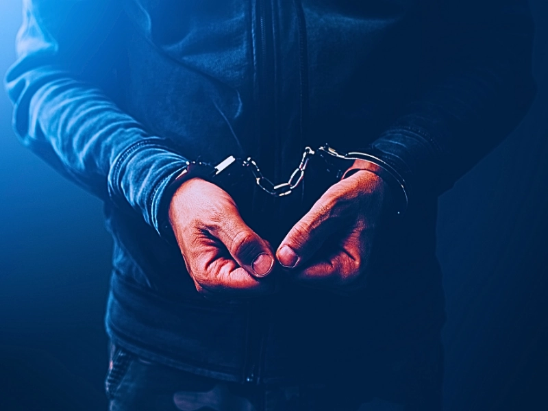 Man in handcuffs. Refusing Arrest vs. Resisting Arrest