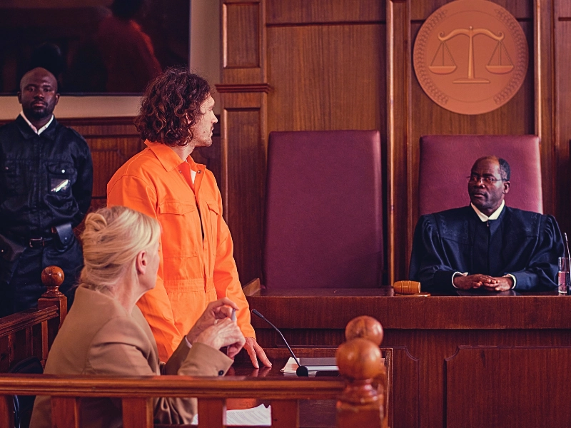 A suspect wearing orange suit facing the judge. What Makes a Crime a Felony